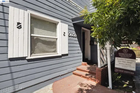 a view of a house with a door and wooden walls