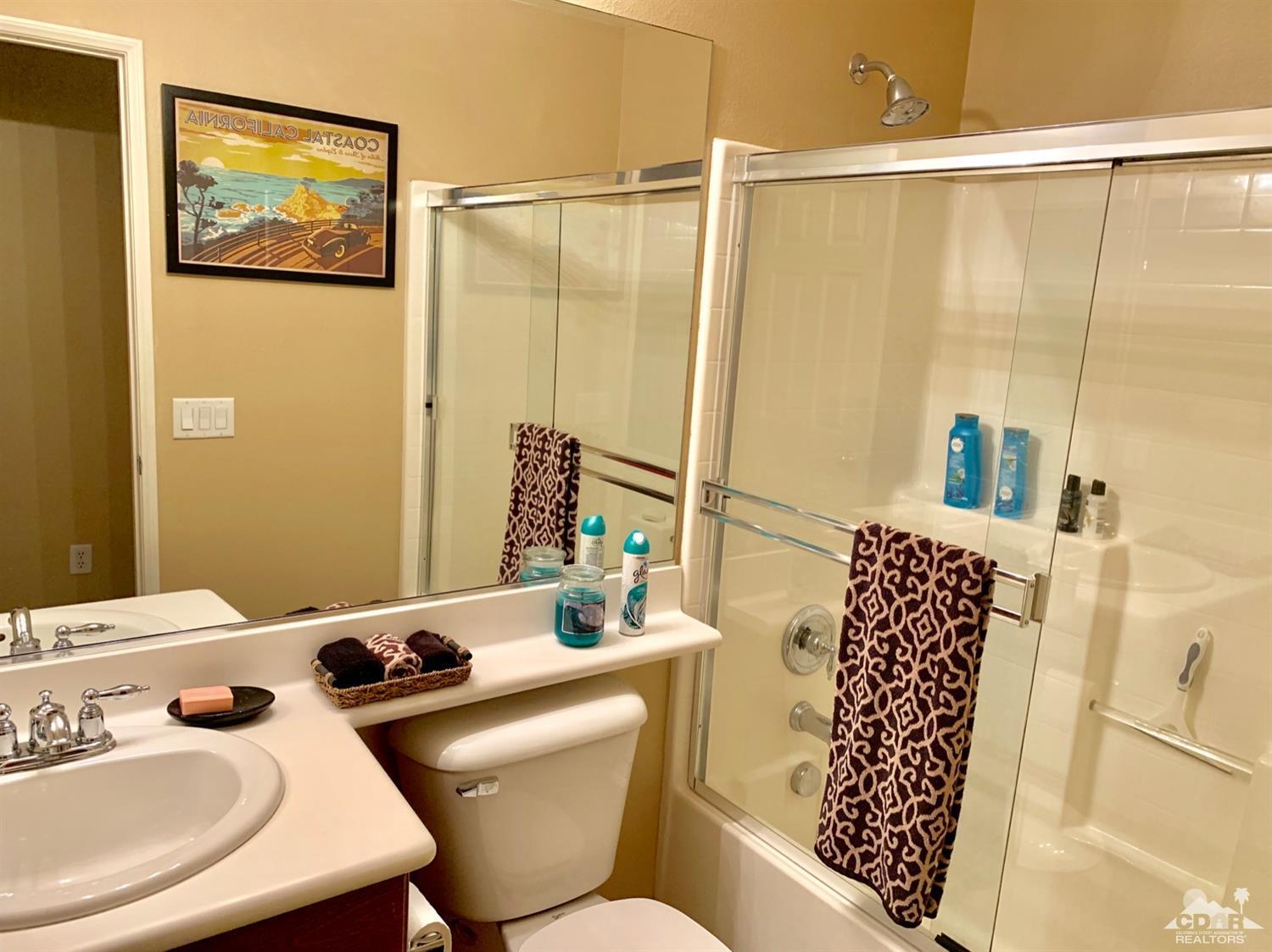 37315 Haweswater Road Indio, CA 92203 - Photo 22 of 24 a bathroom with a sink mirror and a bath tub