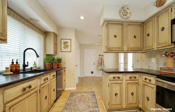 a kitchen with stainless steel appliances granite countertop a sink and cabinets
