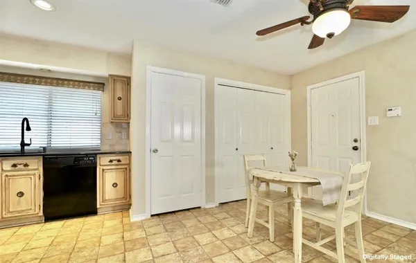 a kitchen with a table and chairs