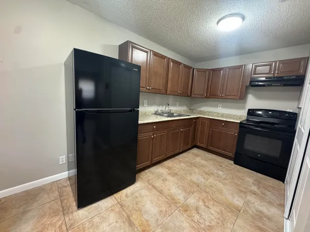 a kitchen with a refrigerator and a sink