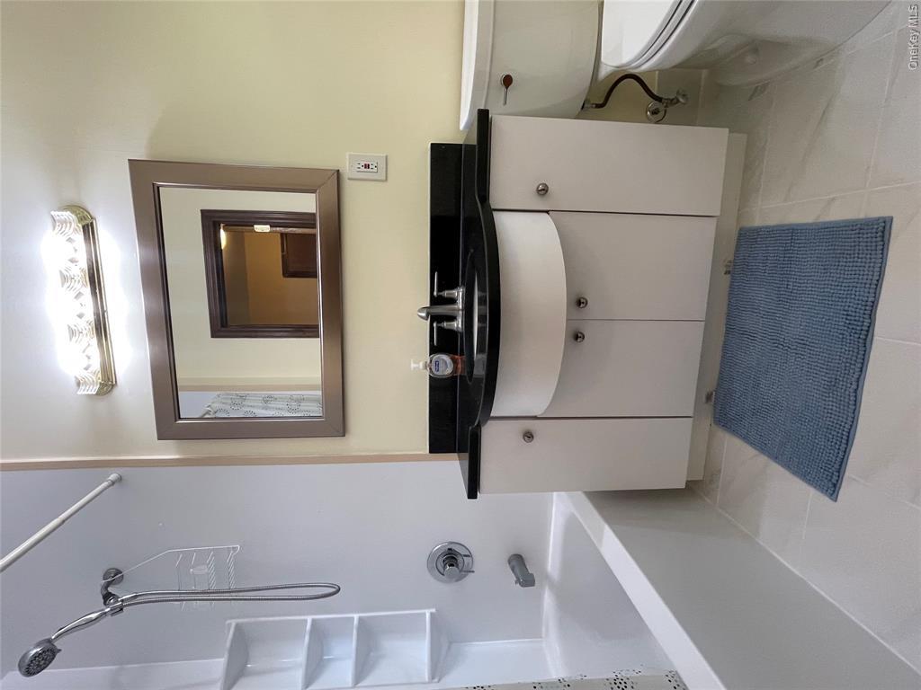 4 Cornwallis Road East Setauket, NY 11733 - Photo 11 of 16 a bathroom with a sink a toilet and bathtub