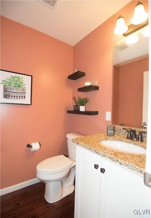 2406 Gentle Hollow Road Whitehall, PA 18052 - Photo 12 of 37 a bathroom with a granite countertop toilet and a sink