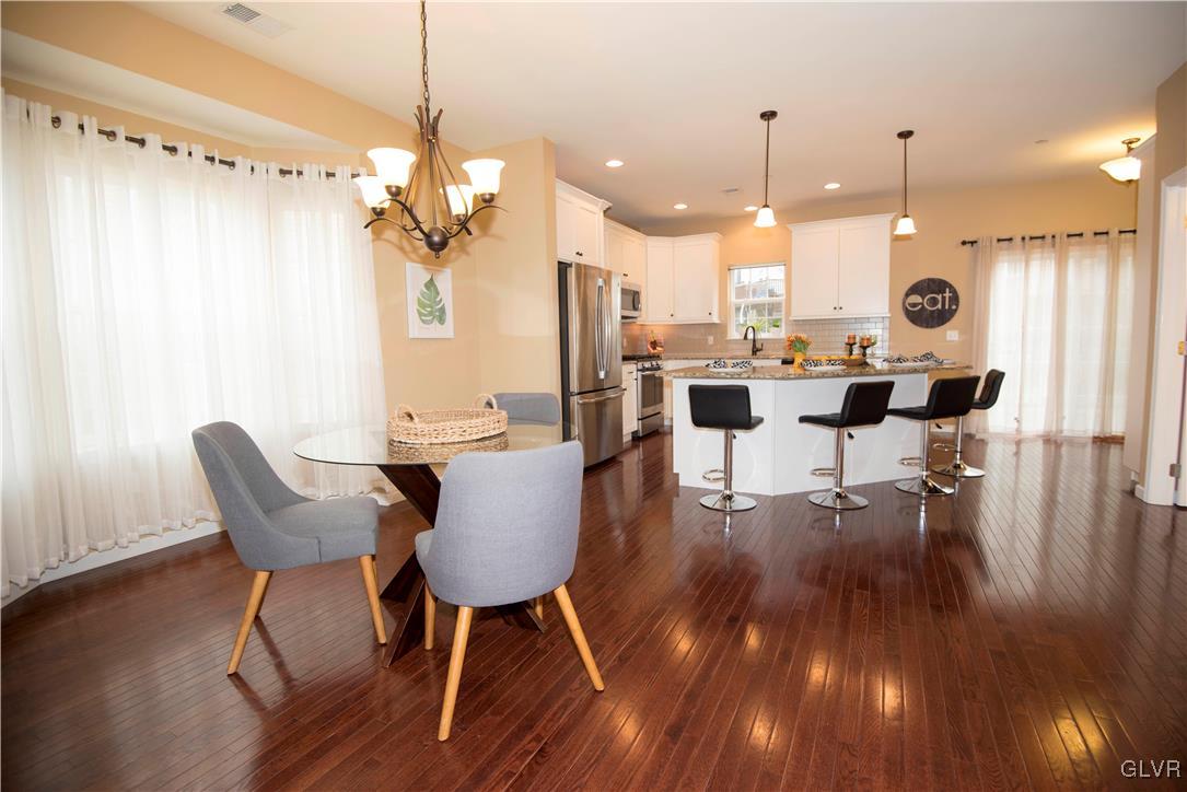 2406 Gentle Hollow Road Whitehall, PA 18052 - Photo 14 of 37 a view of a dining room with furniture wooden floor and chandelier