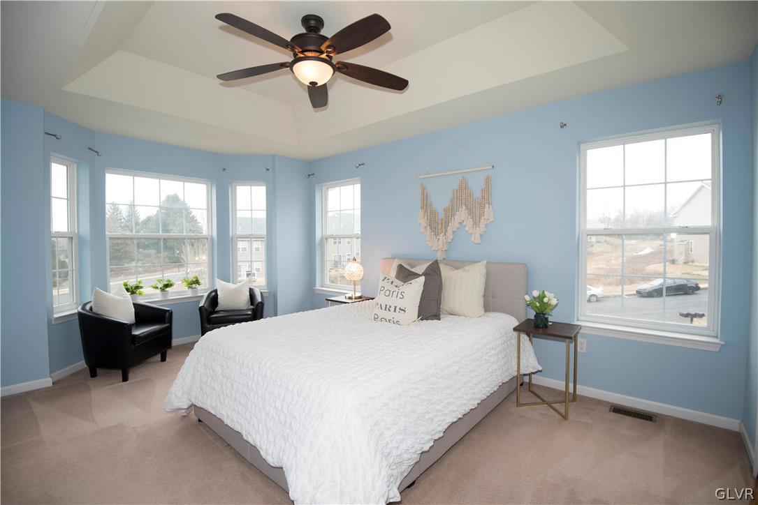 2406 Gentle Hollow Road Whitehall, PA 18052 - Photo 22 of 37 a large bedroom with a large bed and a chandelier fan
