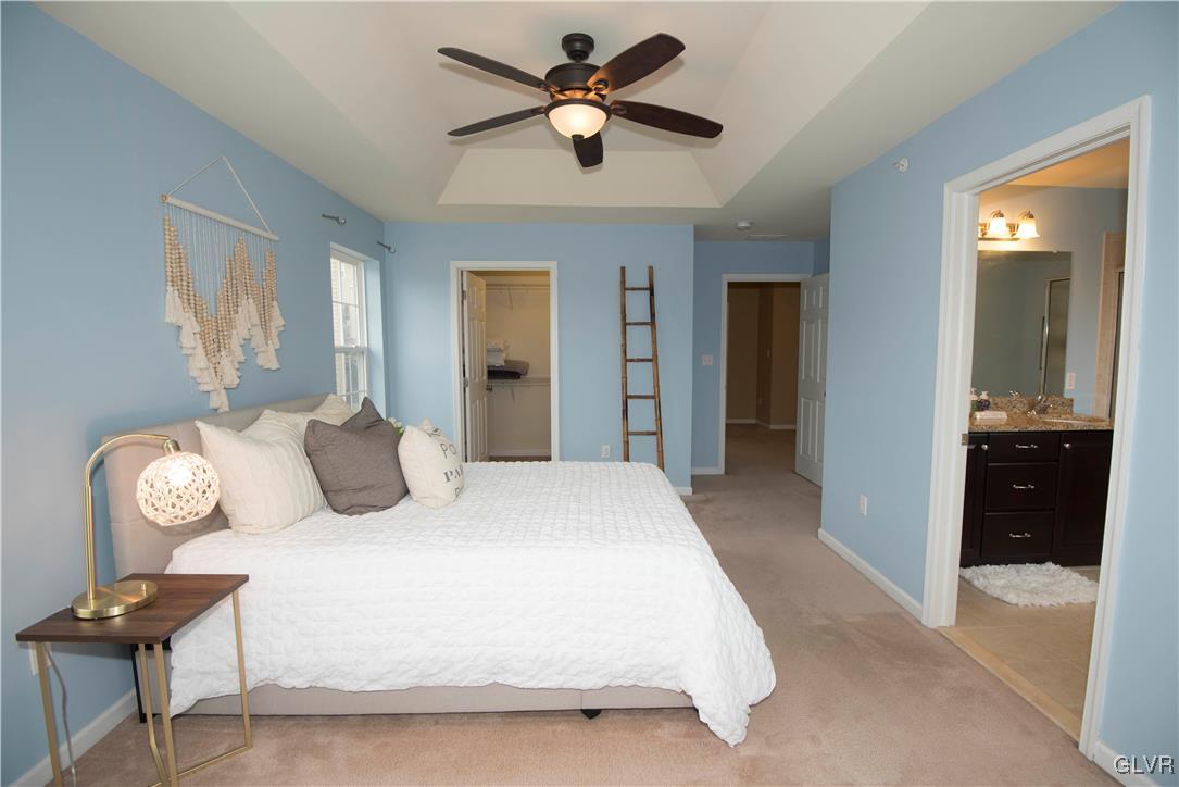 2406 Gentle Hollow Road Whitehall, PA 18052 - Photo 23 of 37 a bedroom with a bed and a chandelier