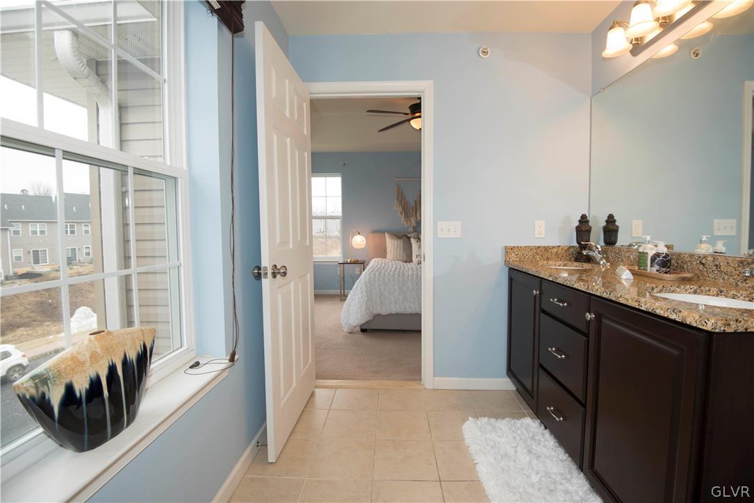 2406 Gentle Hollow Road Whitehall, PA 18052 - Photo 24 of 37 a en suite bathroom with a double vanity sink and a mirror