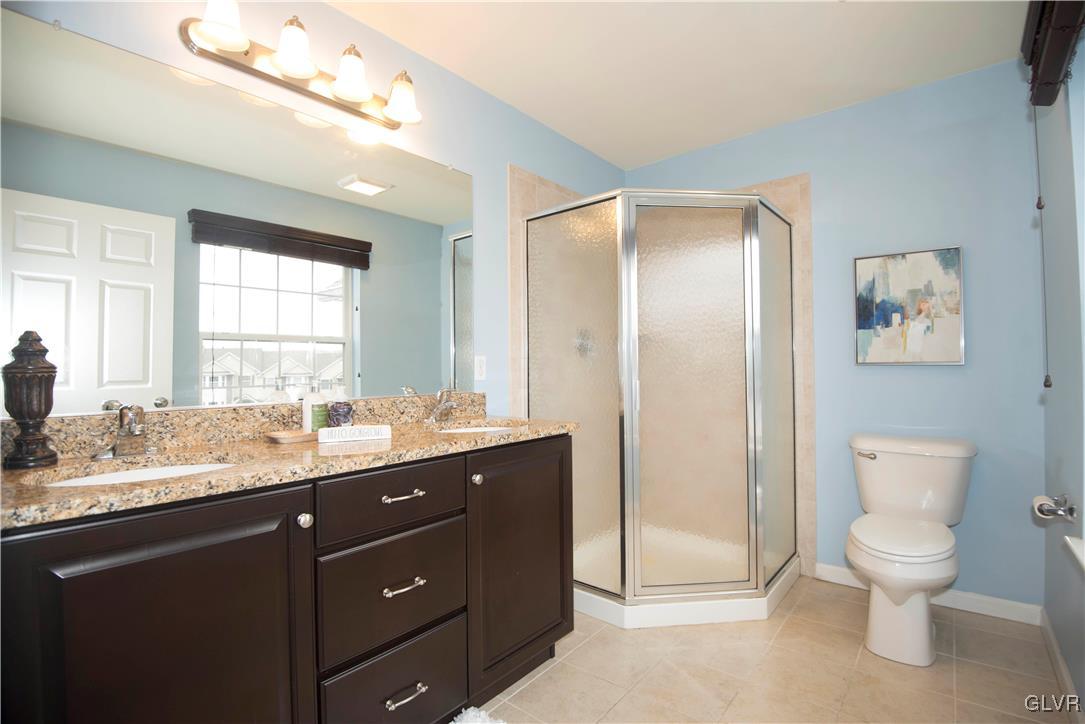 2406 Gentle Hollow Road Whitehall, PA 18052 - Photo 26 of 37 a bathroom with a granite countertop sink toilet and shower