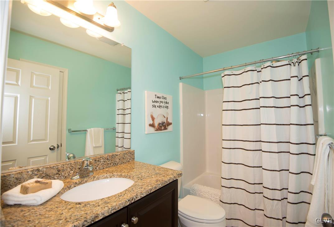 2406 Gentle Hollow Road Whitehall, PA 18052 - Photo 30 of 37 a bathroom with a granite countertop sink mirror vanity and toilet