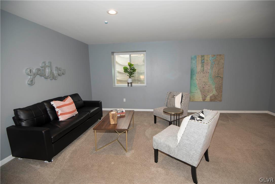 2406 Gentle Hollow Road Whitehall, PA 18052 - Photo 32 of 37 a living room with couches and a flat screen tv