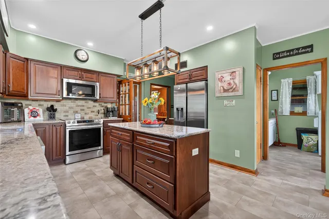 a kitchen with stainless steel appliances granite countertop a stove and cabinets