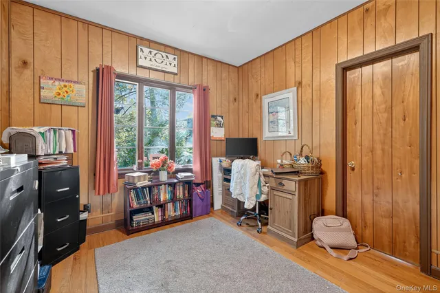 a bedroom with furniture and wooden floor