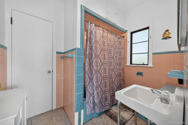 a bathroom with a sink toilet and a mirror