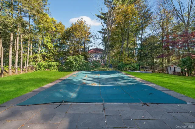 a view of a house with a yard and sitting area