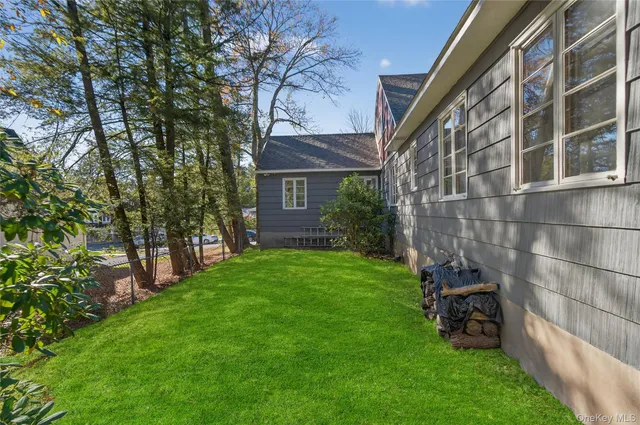 a view of a house with a yard patio and swimming pool