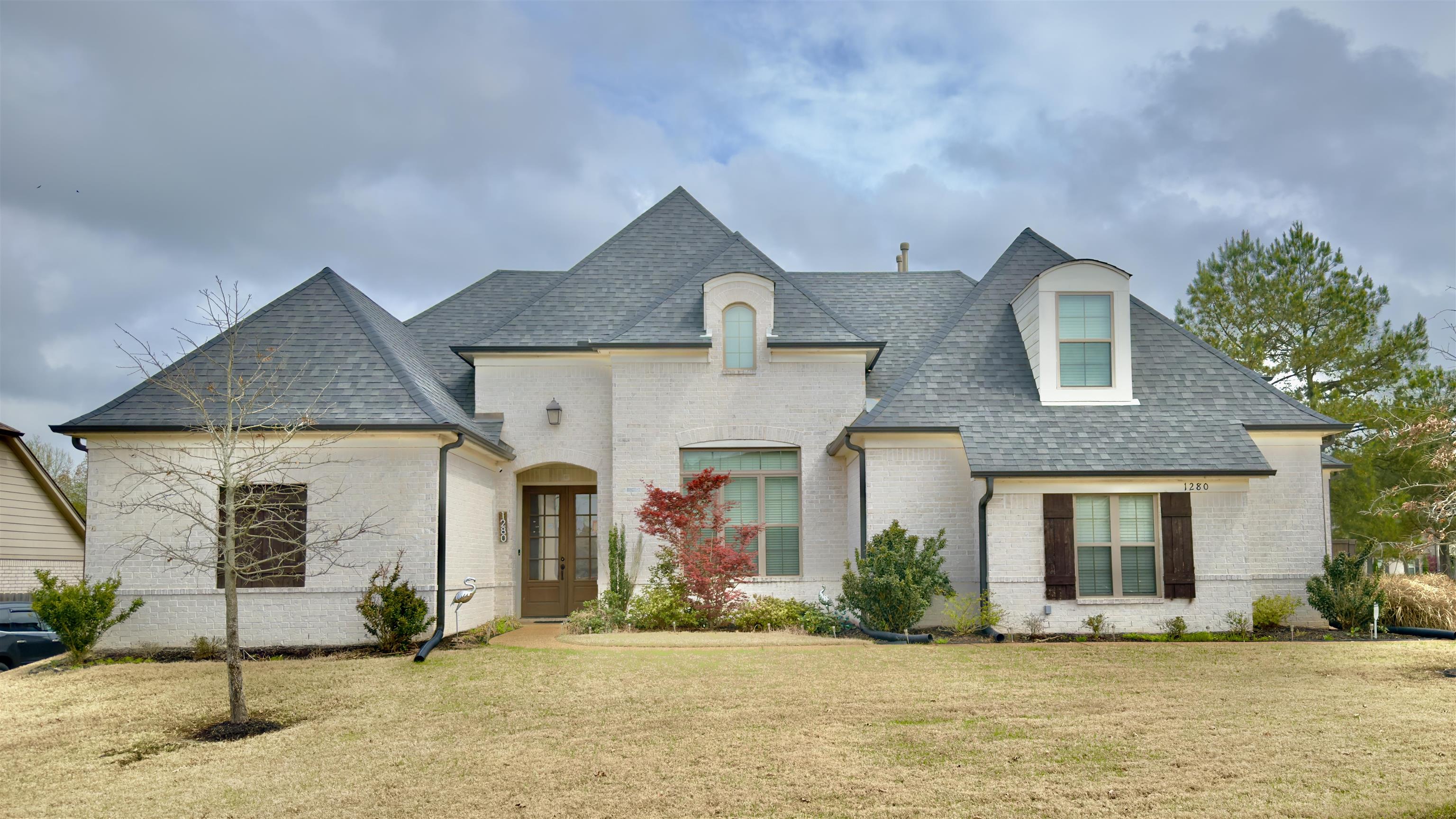 1280 Mountain Side Drive Collierville, TN 38017 - Photo 1 of 29 French provincial home featuring brick siding, roof with shingles, and a front lawn