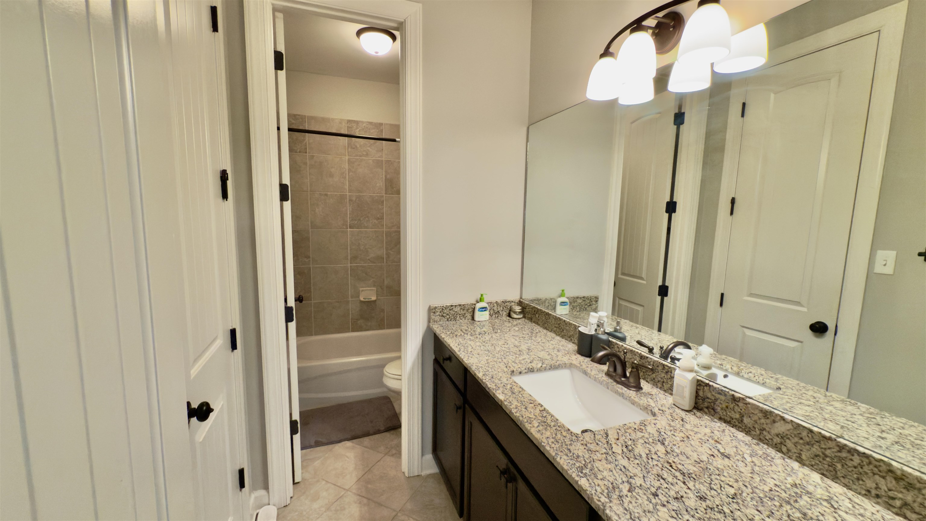 1280 Mountain Side Drive Collierville, TN 38017 - Photo 15 of 29 Bathroom with shower / bathing tub combination, tile patterned floors, toilet, and vanity