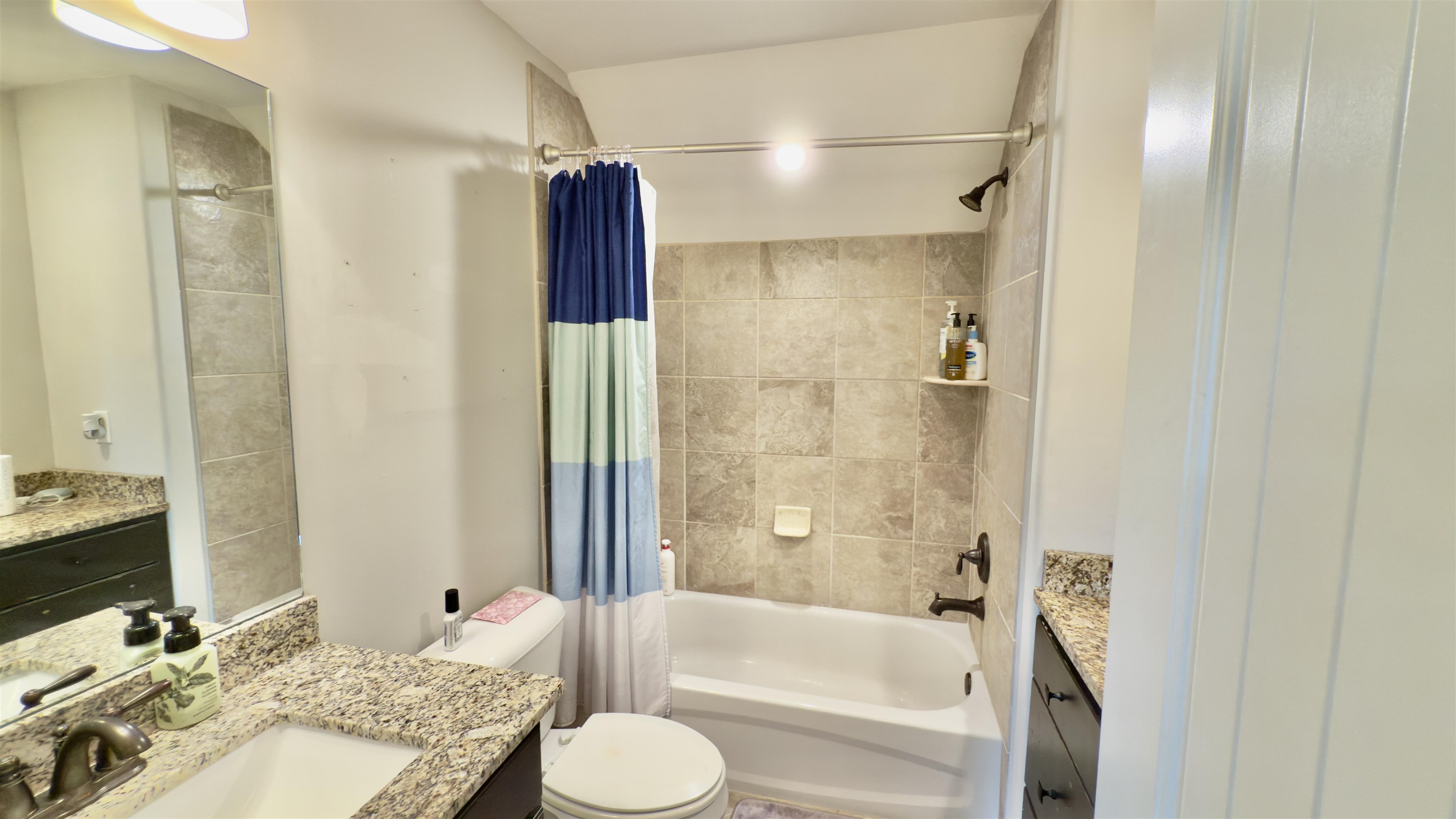 1280 Mountain Side Drive Collierville, TN 38017 - Photo 21 of 29 Bathroom featuring shower / tub combo with curtain, toilet, and vanity