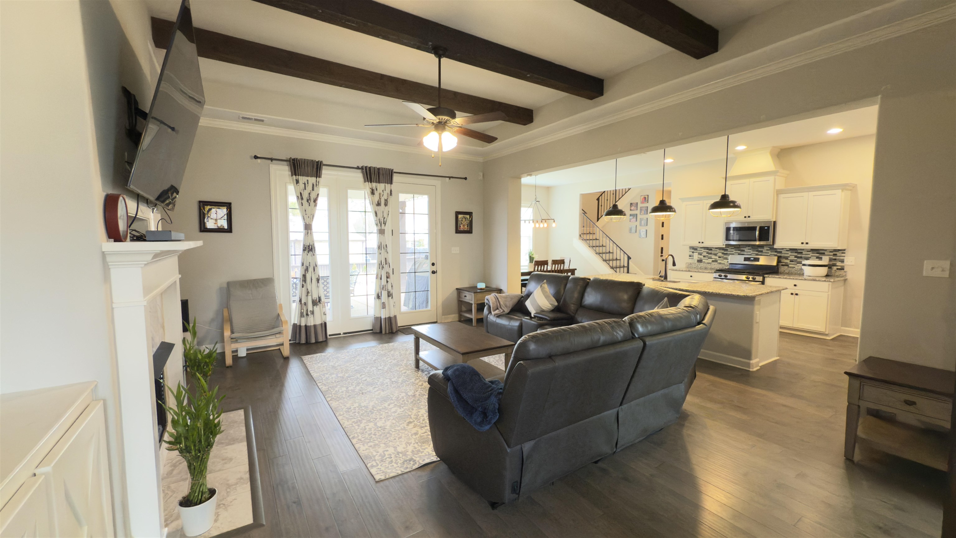 1280 Mountain Side Drive Collierville, TN 38017 - Photo 4 of 29 Living area with a ceiling fan, beam ceiling, stairs, and dark wood finished floors