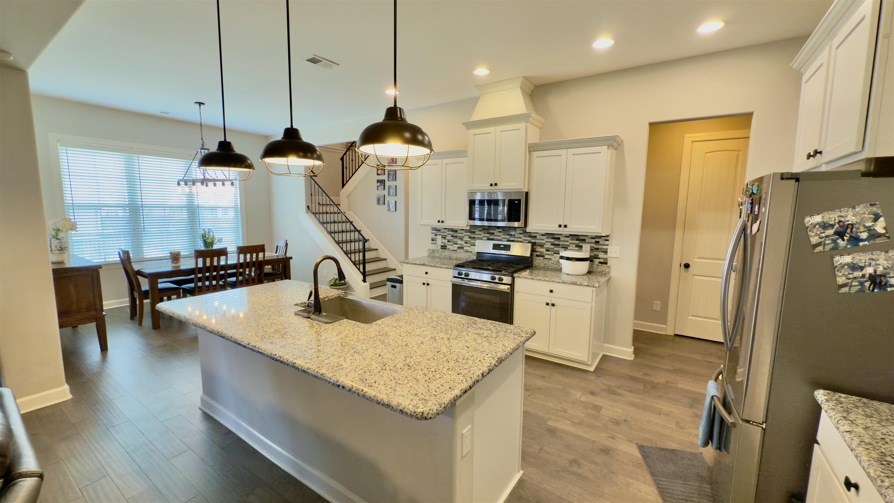 1280 Mountain Side Drive Collierville, TN 38017 - Photo 7 of 29 Kitchen featuring visible vents, stainless steel appliances, white cabinetry, a sink, and backsplash