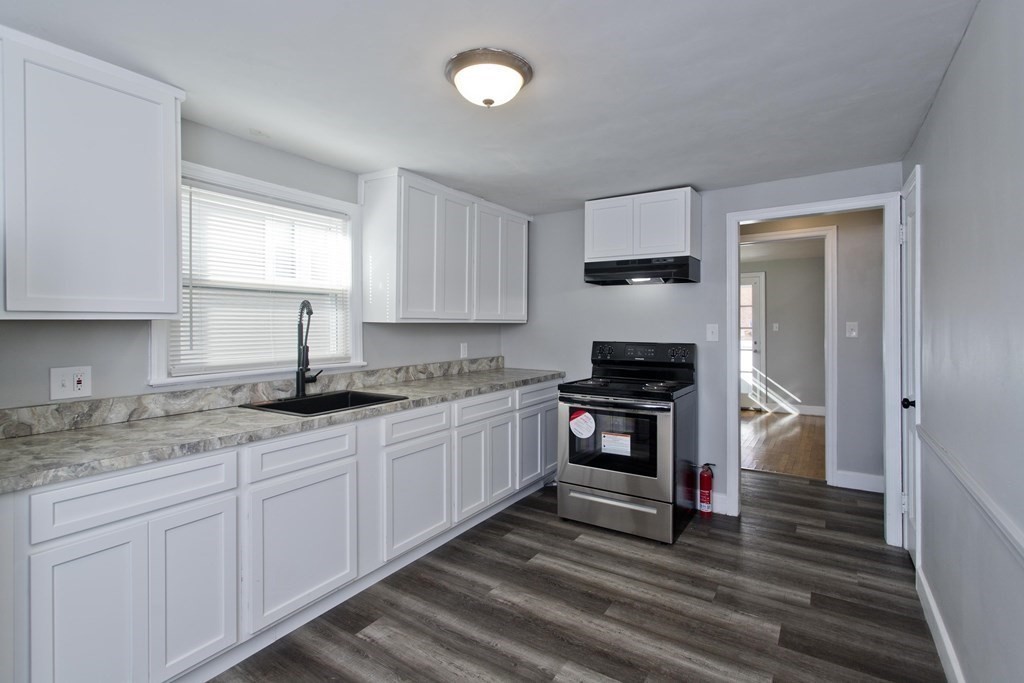 138 Appleton Street Springfield, MA 01108 - Photo 15 of 42 a kitchen with granite countertop a sink cabinets and stainless steel appliances