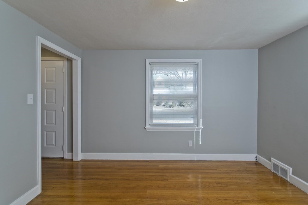 138 Appleton Street Springfield, MA 01108 - Photo 17 of 42 an empty room with wooden floor and windows