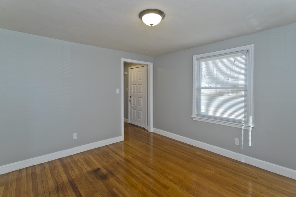 138 Appleton Street Springfield, MA 01108 - Photo 18 of 42 a view of an empty room with wooden floor and a window
