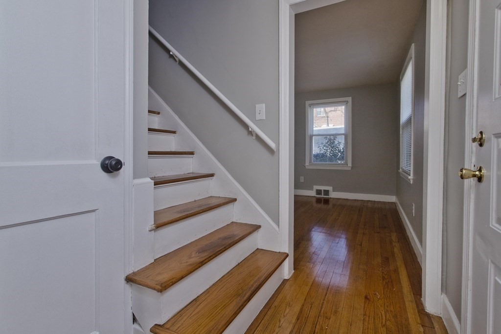 138 Appleton Street Springfield, MA 01108 - Photo 19 of 42 a view of a hallway with wooden floor and staircase