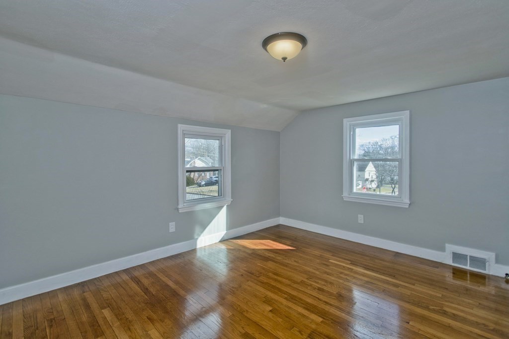 138 Appleton Street Springfield, MA 01108 - Photo 23 of 42 a view of an empty room with wooden floor and a window