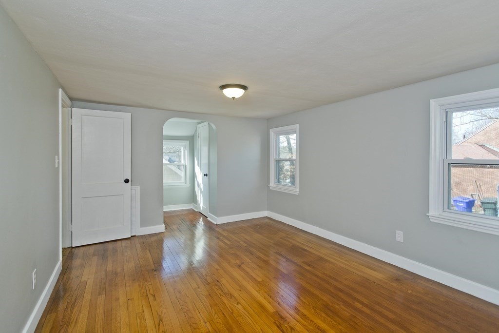 138 Appleton Street Springfield, MA 01108 - Photo 32 of 42 a view of an empty room with wooden floor and a window