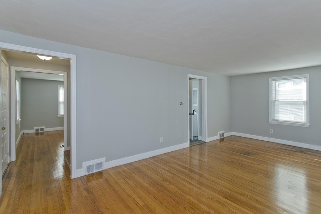 138 Appleton Street Springfield, MA 01108 - Photo 36 of 42 wooden floor in an empty room with a window