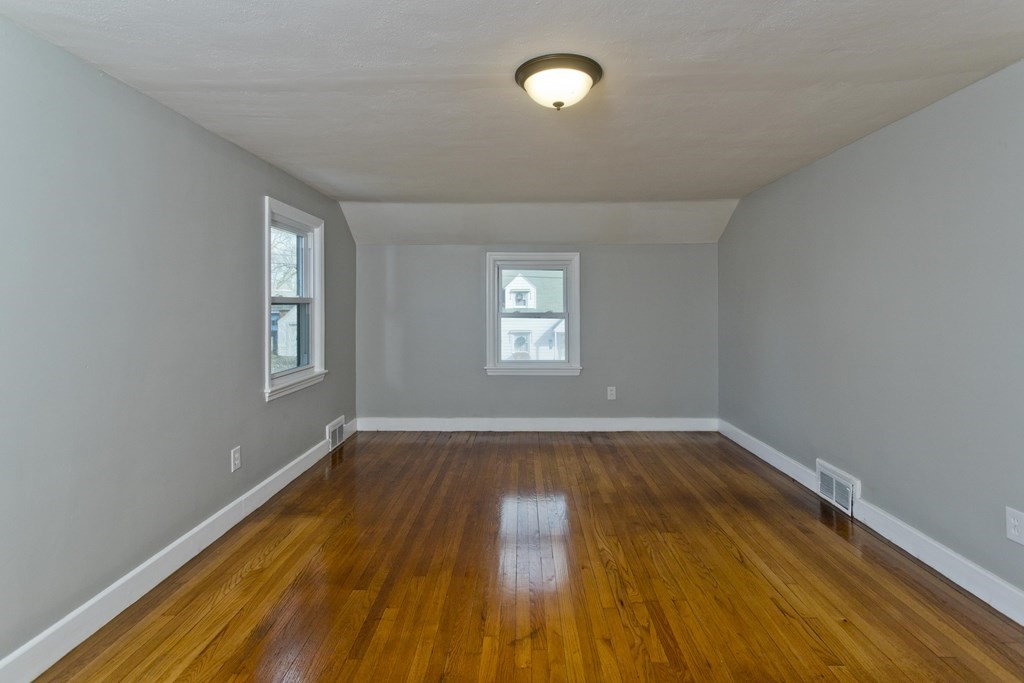 138 Appleton Street Springfield, MA 01108 - Photo 38 of 42 an empty room with wooden floor and windows