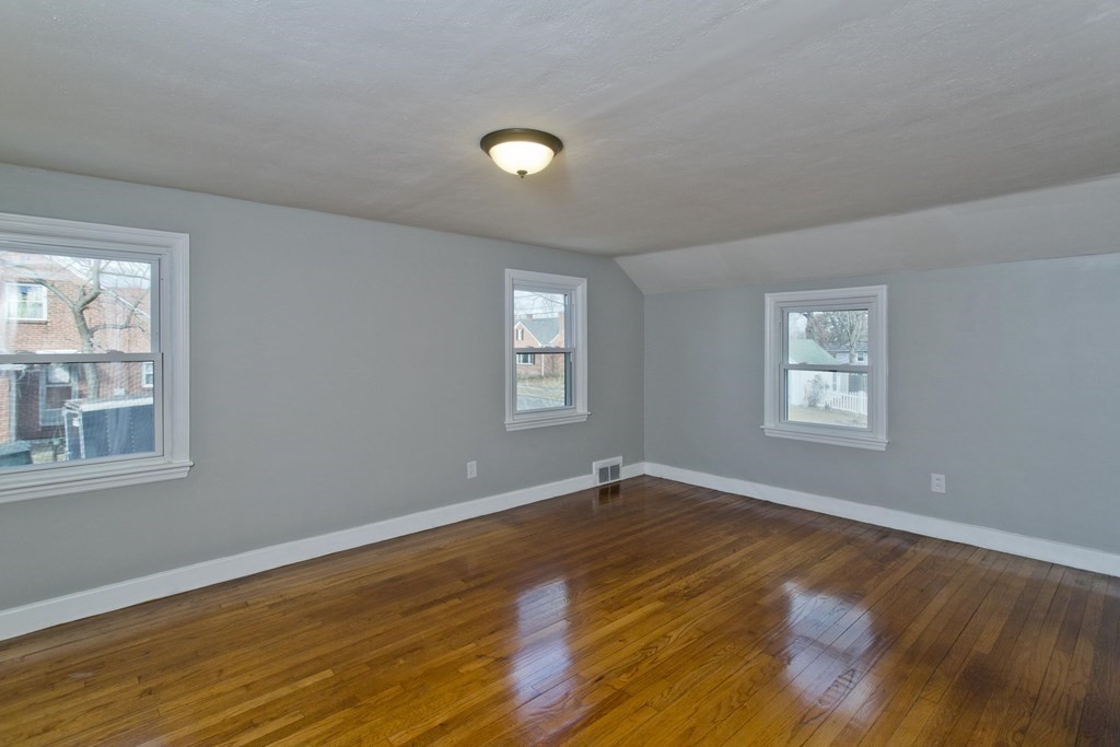 138 Appleton Street Springfield, MA 01108 - Photo 39 of 42 a view of an empty room with wooden floor and a window
