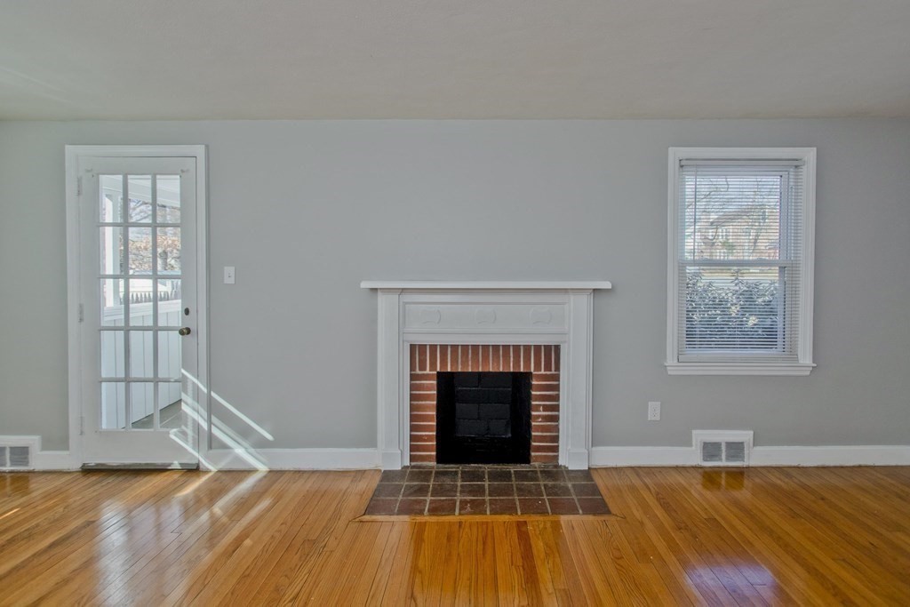 138 Appleton Street Springfield, MA 01108 - Photo 8 of 42 a view of empty room with wooden floor and fireplace