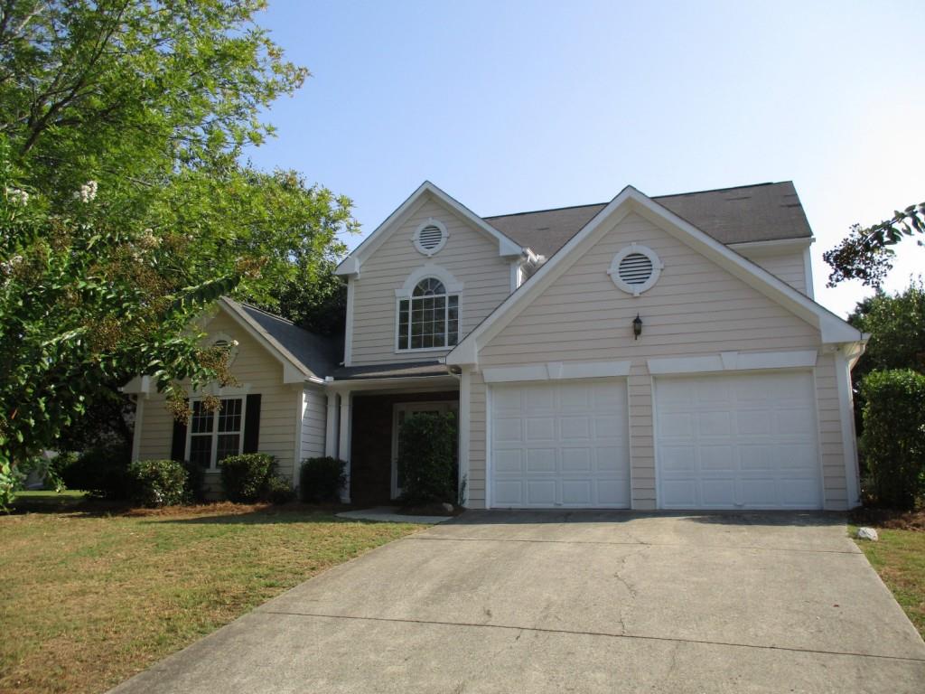 1415 Ridgemill Terrace Dacula, GA 30019 - Photo 1 of 1 a front view of a house with a yard and garage