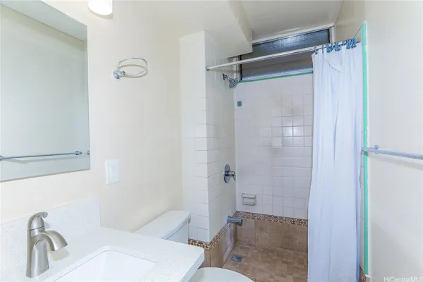 a bathroom with a toilet sink and shower