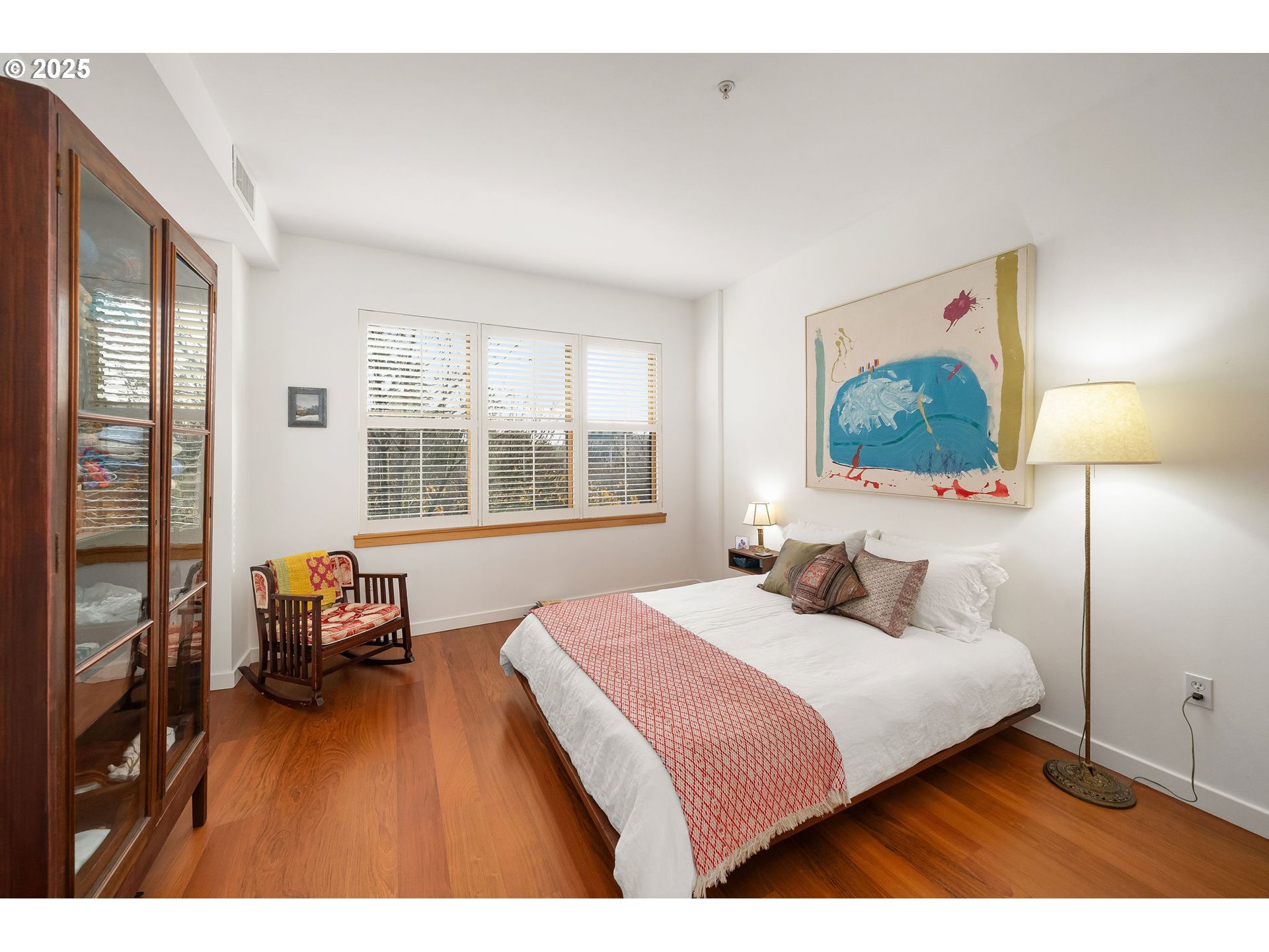 821 Northwest 11th Avenue, Unit 321 Portland, OR 97209 - Photo 26 of 48 a bedroom with a bed and wooden floor