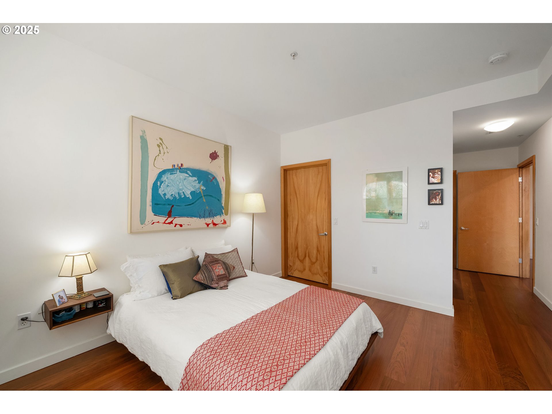821 Northwest 11th Avenue, Unit 321 Portland, OR 97209 - Photo 27 of 48 a bedroom with a bed and a painting on the wall