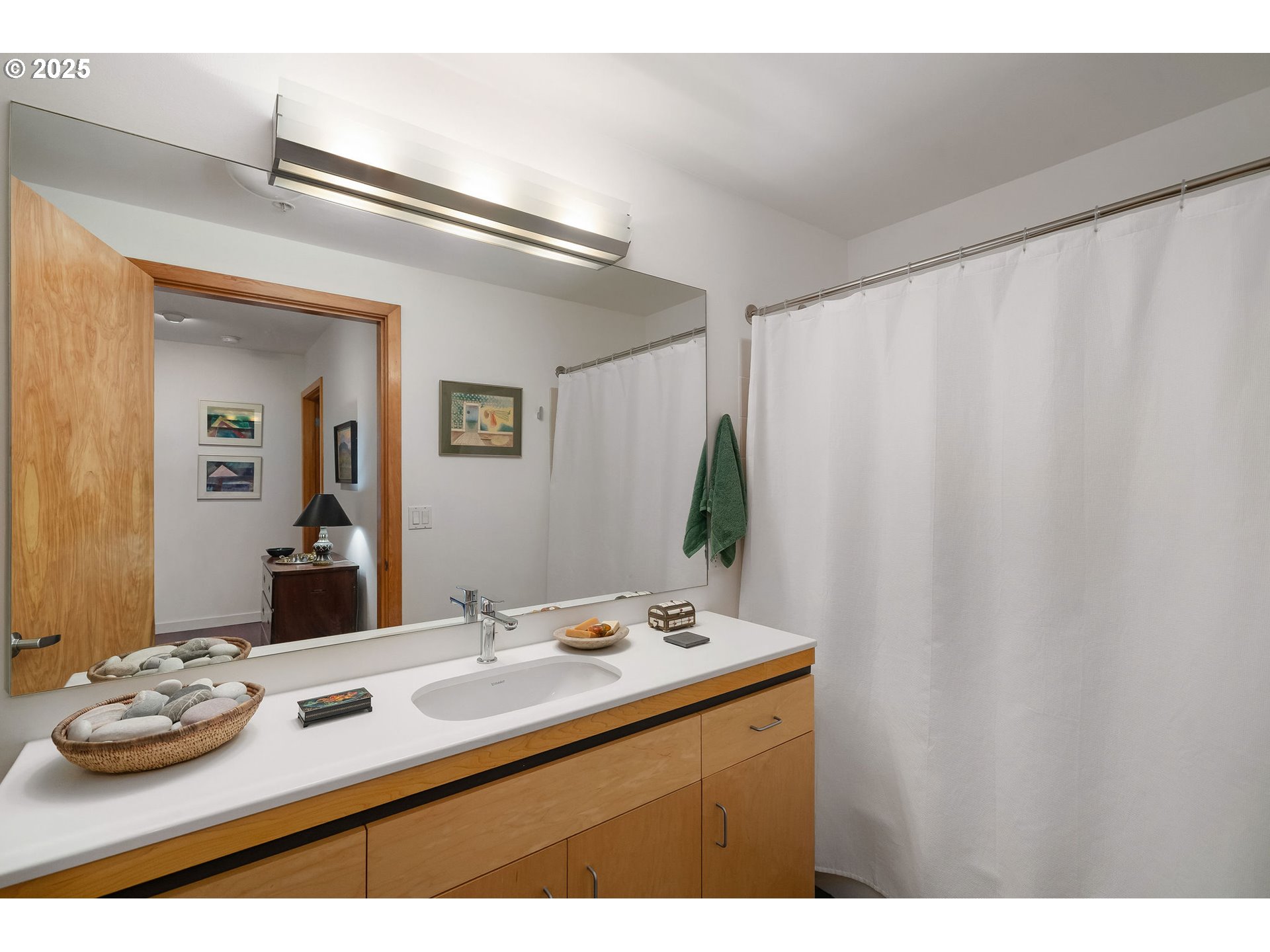 821 Northwest 11th Avenue, Unit 321 Portland, OR 97209 - Photo 31 of 48 a bathroom with a sink and a mirror