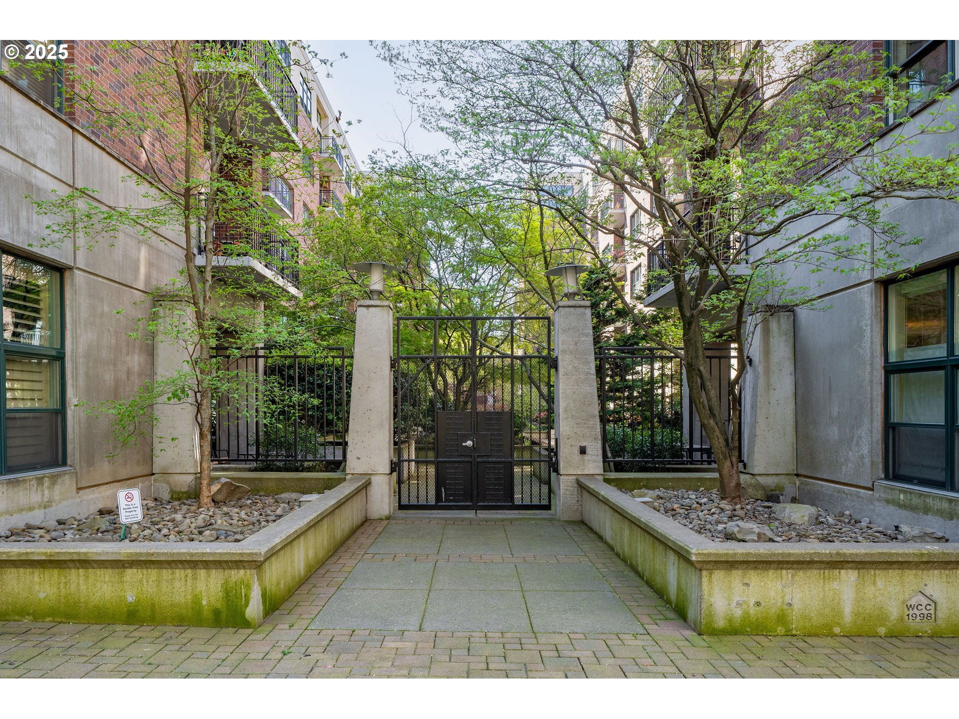 821 Northwest 11th Avenue, Unit 321 Portland, OR 97209 - Photo 44 of 48 a front view of a house with a yard