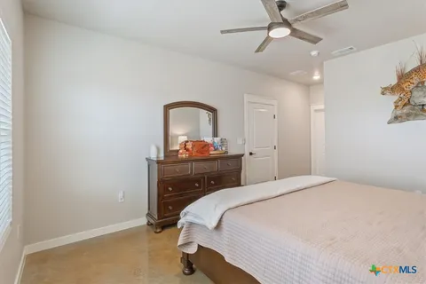 a bedroom with a bed and a dresser
