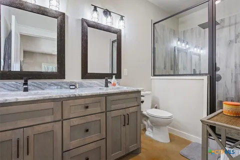 a bathroom with a double vanity sink and a mirror