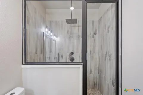 a bathroom with a granite countertop sink and mirror