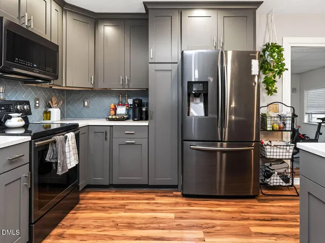 a kitchen with stainless steel appliances granite countertop a refrigerator stove and microwave