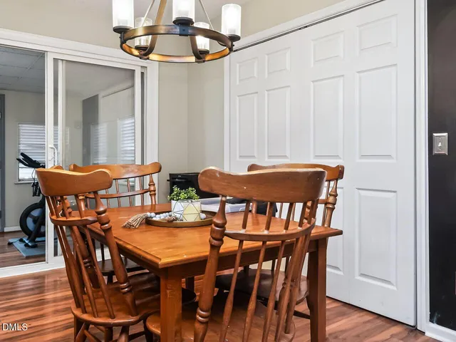 a view of a dining room with furniture and wooden floor