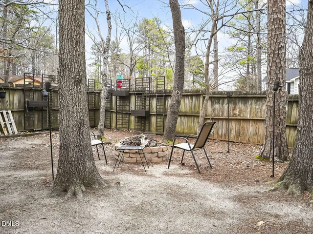 a view of a chairs and table in backyard