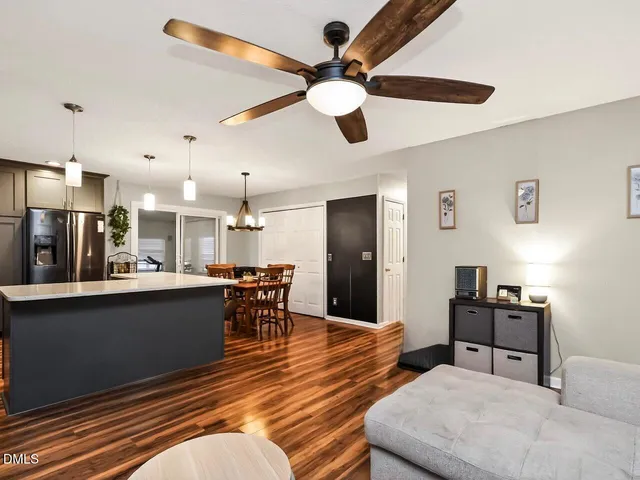 a living room with furniture and kitchen view