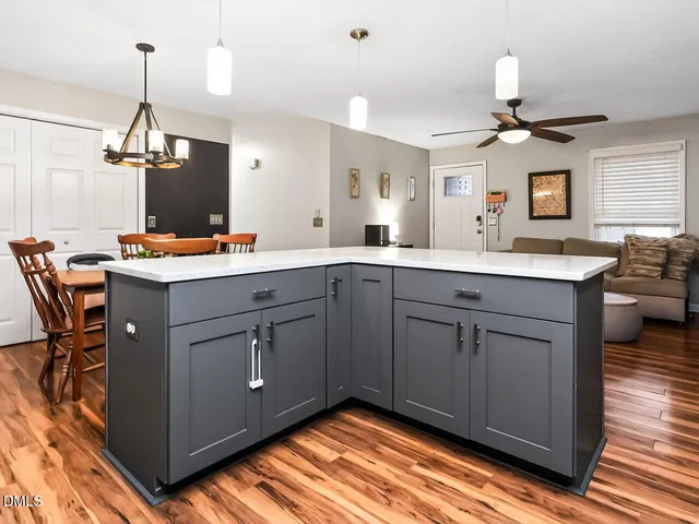 a kitchen with a sink window and cabinets