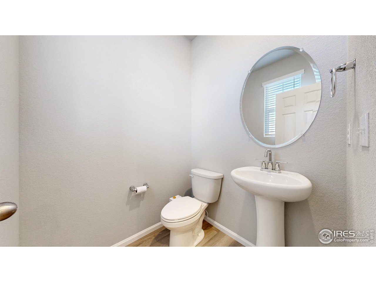 229 East 4th Street Berthoud, CO 80513 - Photo 18 of 49 a bathroom with a sink toilet and a mirror