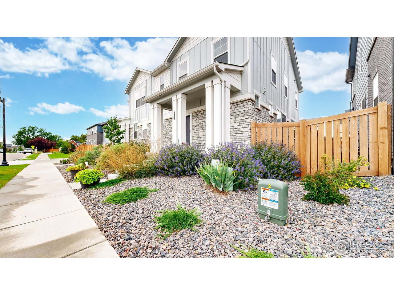 229 East 4th Street Berthoud, CO 80513 - Photo 2 of 49 a front view of a house with a yard garage and outdoor seating